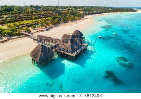 Aerial View Of Beautiful Hotel On The Water In Ocean At Sunset In Summer. Zanzibar, Africa. Top View