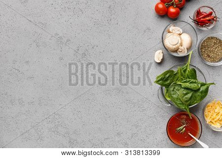 Ready For Cooking Pizza. Ingredients, Vegetables And Herbs On Grey Table With Copy Space