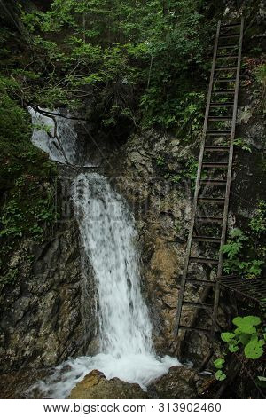 Dangerous Trail Through A Waterfall With Steel Ladders In The Slovak Paradise National Park, Slovaki