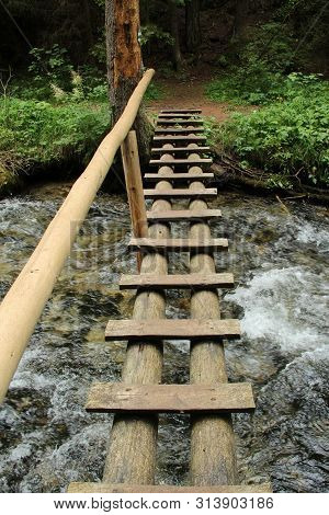 Dangerous Trail Through A Waterfall With Wooden Ladders In The Slovak Paradise National Park, Slovak