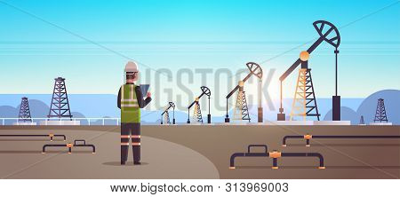 Male Engineer Refinery Worker Using Tablet Oil Pump Rig Energy Industrial Zone Oil Drilling Fossil F