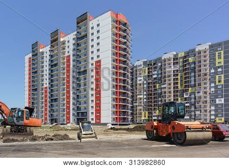 Landscaping Around The New Bright Residential Complex. Asphalt Laying And Landscaping. Technology Of