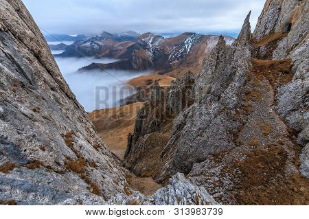 Beautiful Scenic Dramatic Autumn Landscape Of Bolshoy Tkhach Rocky Mountain Ridge Under Cloudy Sky A
