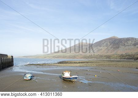 Trefor Beach, Wales. Two Small Fishing Boats At A Secluded Bay Near Snowdonia On The Llyn Peninsula 