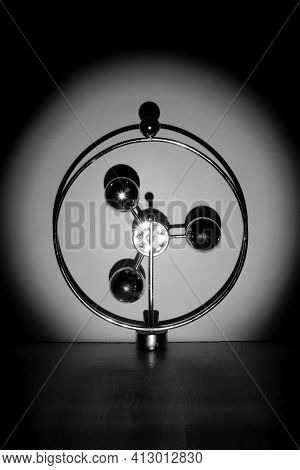 Abstract Metal Construction With Shiny Balls In Spotlight Beam On White Background