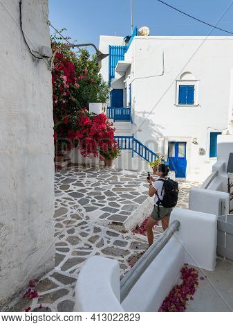 Parikia, Paros Island, Greece - 26 September 2020: A Woman With A Camera Exploring The Old Town Of P
