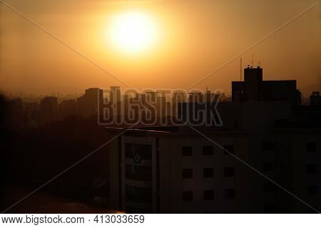 The Fall Of The Sun In The Middle Of The Buildings Of São Paulo. The Urban Sky Line Of São Paulo Ill