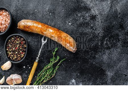 Pork Sausage Bbg Grilled With And Herbs On A Meat Fork. Top View. Black Background. Copy Space