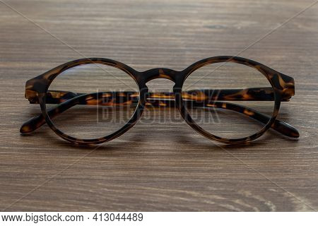Eye Glasses On The Wooden Office Table
