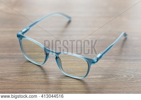 Eyeglassed Blue Color On Wooden Table Office