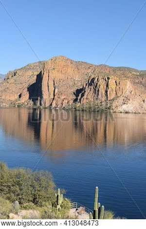 Canyon Lake, Arizona, in the Tonto National Forest the lake is formed by the Mormon Flat Dam on the Salt River. Vertical image with Saguaro on the closest shore.