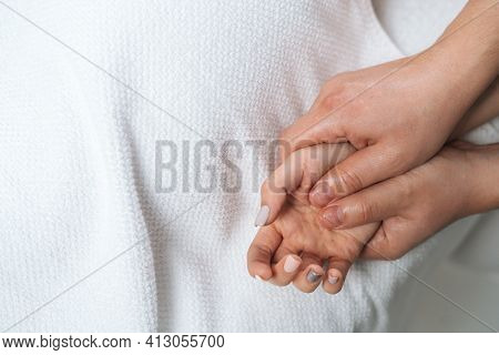 Close-up Of Male Physiotherapist Doing Finger And Palm Massage To Young Woman At Spa Salon. Man Phys