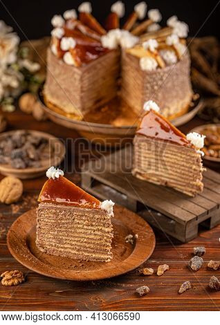 Two Pieces Of Chocolate Cake Dobosh On Wooden Background