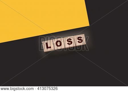 Wooden Cubes With Loss Word On Blacktable. Financial Loss Busines Concept.