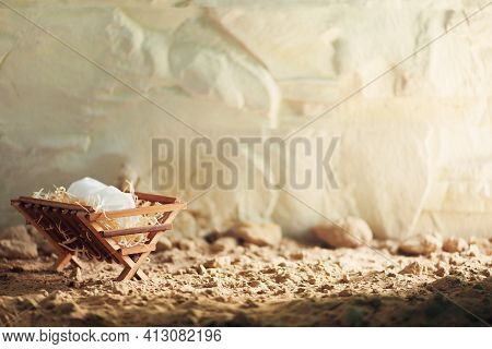 Christian Christmas Concept. Birth Of Jesus Christ. Wooden Manger In Cave Background. Banner, Copy S