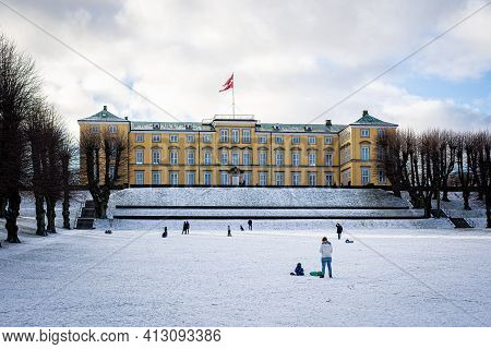 Copenhagen, Denmark - January 06, 2021: People Enjoying A Snowy Winter Day In Front Of The Palace In