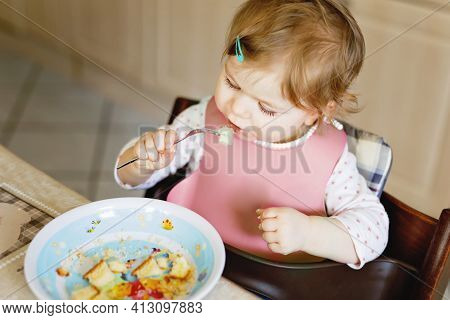 Adorable Baby Girl Eating From Spoon Mashed Vegetables And Puree. Food, Child, Feeding And People Co
