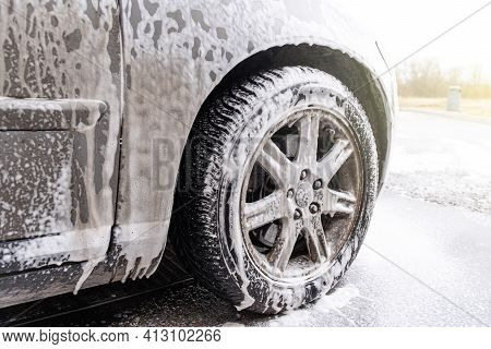 Car Covered With Washing Foam At Contactless Car Washing Service