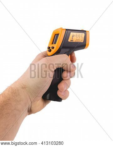 A Man Holds A Yellow-black Pyrometer. A Device For Non-contact Temperature Measurement. Studio Photo