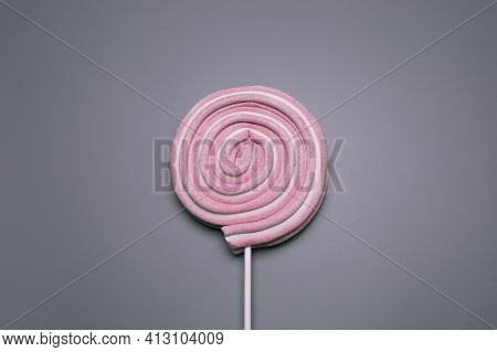 Pink Lolly Pop On The Grey Background.