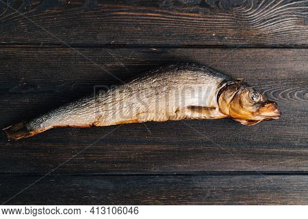 Dried Fish Lies On A Wooden Table Top View Texture