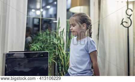 Cute Little Girl Sitting Near Portable Air Purifier In The Living Room At Home, New Technology To Pr