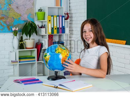 Cute Teen Girl Near Chalkboard With Geaography Globe, Back To School