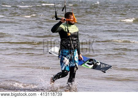 A Young Man Is Engaged In Extreme Kiteboarding In The Gulf Of Riga On October 21, 2020 At Cape Kolka