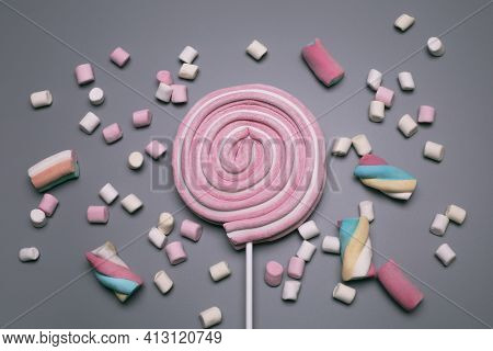 Marshmallows And Lolly Pop On The Grey Background.