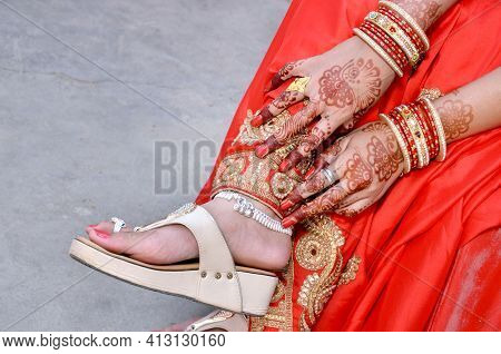 Indian Bridal Showing Her Footwear ,payal And Mehandi On Her Wedding Day
