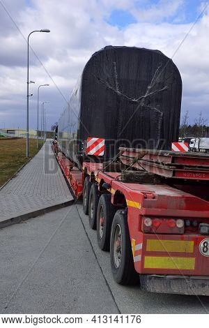 Oversize Load Or Exceptional Convoy. A Truck With A Special Semi-trailer For Transporting Oversized 
