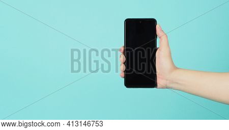 Empty Hand Holding Mobile Phone Guesture On Green And Blue Or Mint Background.