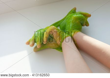The Child Has A Green Slime In His Arms. Green Slime For The Game.