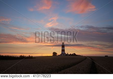 Dramatic Sunset Colour In The Sky On The Norfolk Coast At Happisburgh With The Iconic Lighthouse In 