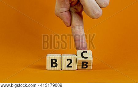 Business To Business Or Busness To Consumer. Businessman Turns A Cube And Changes Words 'b2c' To 'b2