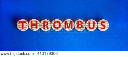 Medical And And Thrombus Symbol. Wooden Circles With The Word 'thrombus'. Beautiful Blue Background.