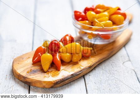 Pickled red and yellow hot chili peppers