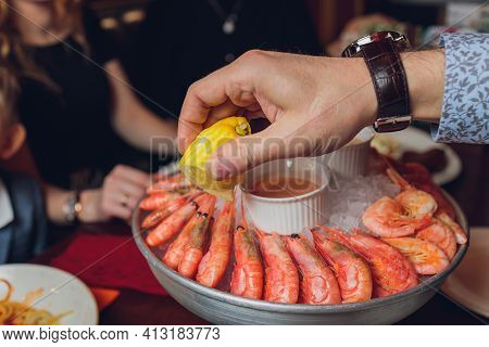 Shrimp With Tomatoes And Feta Cheese On A Plate On A Table Close-up. Horizontal.