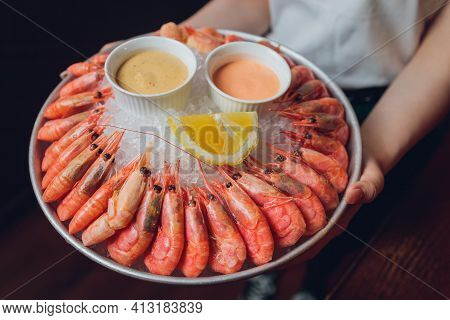 Shrimp With Tomatoes And Feta Cheese On A Plate On A Table Close-up. Horizontal.