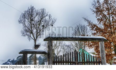 Snowy Old Garden Gate In Village Courtyyard. Snowy Wooden Gate After A Blizzard. Winter Background.