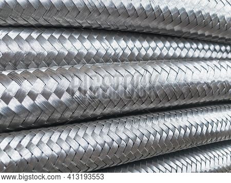 Long Metal Flexible Compensator Pipes Metal Texture Closeup. Selective Focus. White Metal Industrial