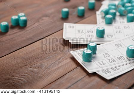 Many Barrels With Numbers And Cards For Lotto Or Russian Bingo Table Game On Wooden Surface. Russian