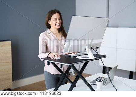 Adjustable Height Desk Stand In Office Using Computer