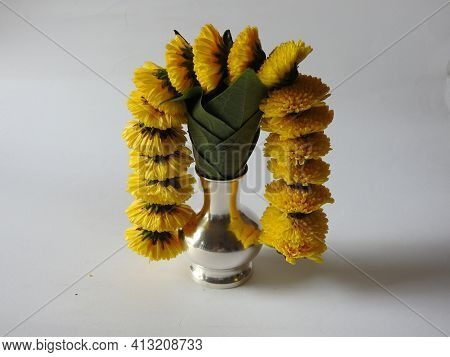 Closeup Of Silver Kalash Decorated With Chrysanthemum Flower, Leaf, Coconut, Kumkum And Turmeric Wit