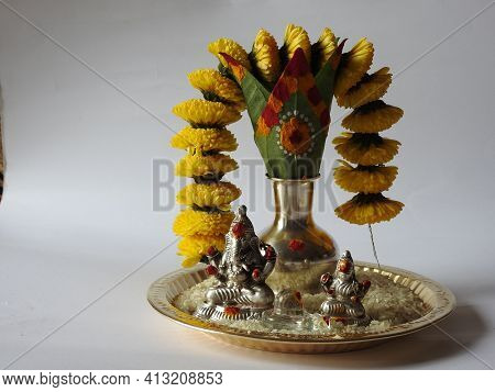 Closeup Of Silver Kalash Decorated With Chrysanthemum Flower, Leaf, Coconut, Kumkum And Turmeric Wit