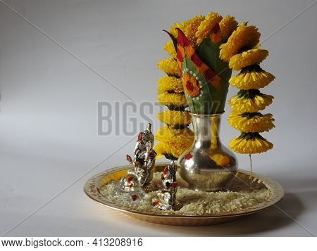Closeup Of Silver Kalash Decorated With Chrysanthemum Flower, Leaf, Coconut, Kumkum And Turmeric Wit