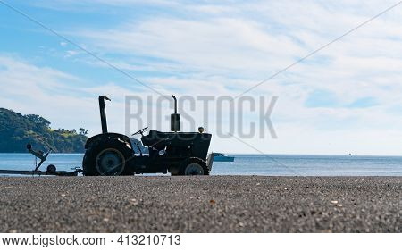 Silhouette Of Tractor Parked On Mulberry Grove Beach Great Barrier, New Zealand