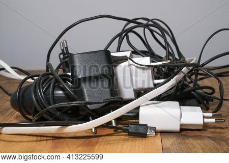 Pile Of Used Smartphone Wired Chargers, Electronic Waste, Tech Device Tools