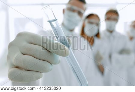 background image is a group of medical workers working with liqu