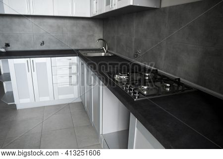Modern Minimalism Style Kitchen Interior In Monochrome Tones. Custom Kitchen With Grey White Facades